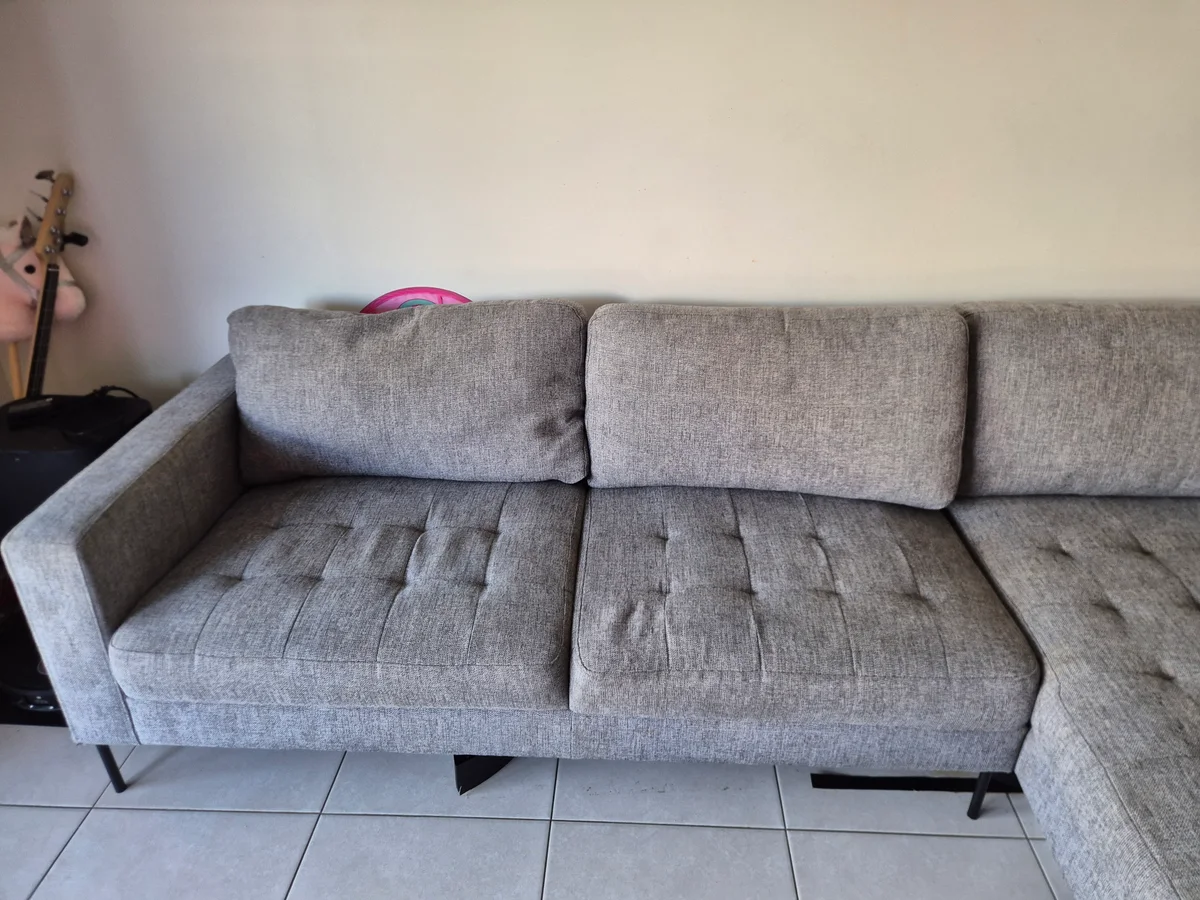 The same grey sofa cushions after stain treatment
